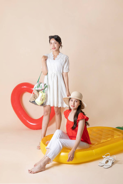 summer vacation trip with friends concept series_korean beautiful asian young women sitting on pool floats - Valokuva, kuva