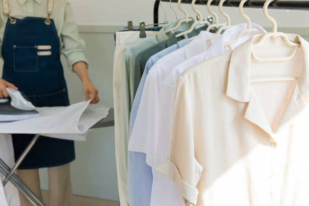 aesthetic laundry concept_ironing shirt with clothes rack background - Foto, Imagem