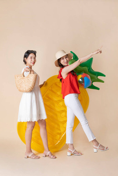 summer vacation trip with friends concept series_korean beautiful asian young women walking holding a tube and pool float ball - Zdjęcie, obraz