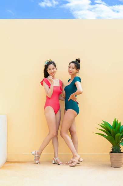 summer vacation trip with friends concept series_korean beautiful asian young women smiling in monokini swimsuits - Фото, изображение