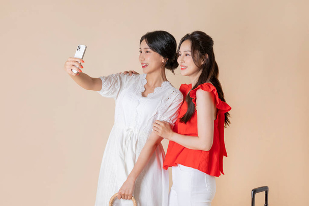 summer vacation trip with friends concept series_korean beautiful asian young women taking a selfie with carrier - Фото, зображення