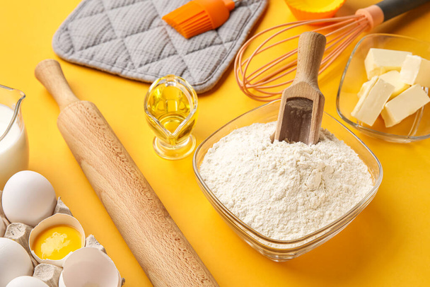 Ingredients for baking and wooden rolling pin on color background - Photo, Image