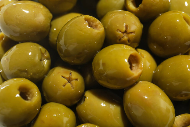 Heap of green olives as background, closeup - Foto, immagini