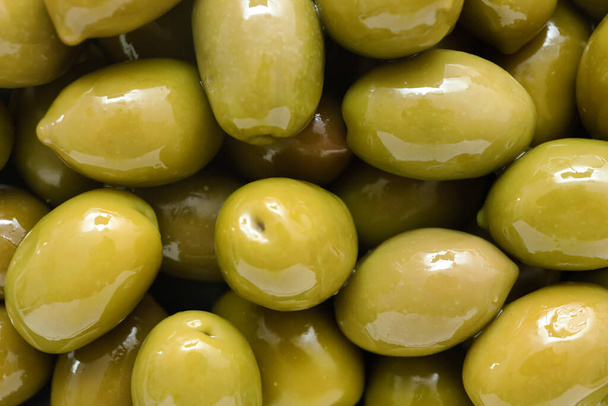 Delicious green olives as background, closeup - 写真・画像
