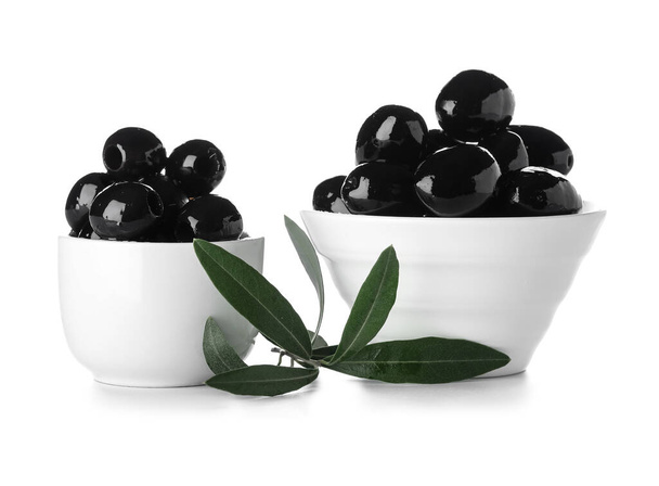 Bowls of tasty black olives on white background - Fotó, kép