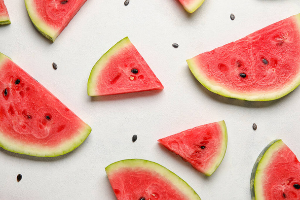 Slices of watermelon and seeds on white background - Foto, afbeelding