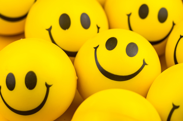 Happy faces ball on yellow background, smiling background. - Photo, image