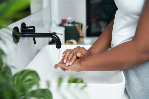 Close up of African-American person washing hands in the sink - Φωτογραφία, εικόνα