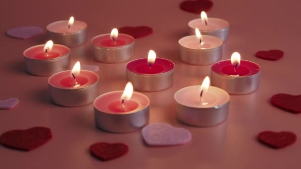Candles on a pink background. Love concept. High quality 4k footage - Materiał filmowy, wideo