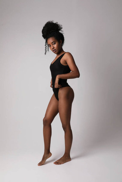 African American woman with perfect body posing indoor looking aside. Mock-up. High quality photo. - Foto, Imagen