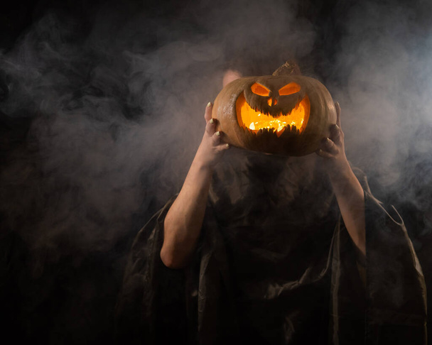 Pumpkin jack o lantern instead of a womans head. Halloween. - Photo, image