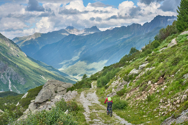 nice active senior woman riding her electric mountain bike in the silvretta mountain range near Gaschurn, Tyrol, Austria - Zdjęcie, obraz