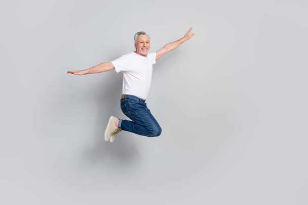 Full length body size view of attractive cheery free lucky man jumping flying isolated over grey pastel color background. - Valokuva, kuva