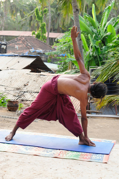 the utthita trikonasana or triangle pose, an exercise in yoga - Foto, Bild