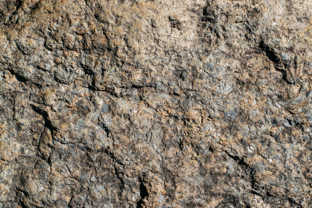 Raw granite rock texture background. Fragment of natural stone wall. - Foto, Imagen
