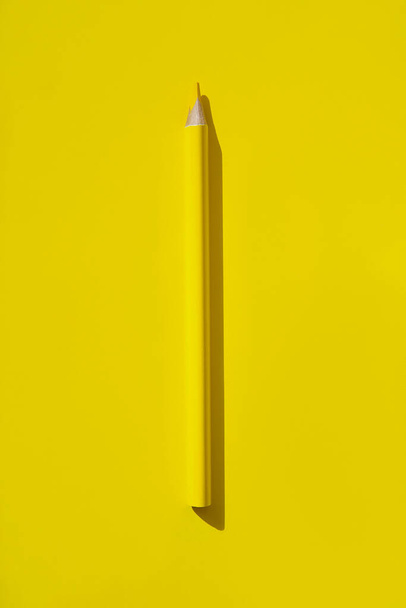 Minimal style composition made of wooden pencil on yellow background. Top view. Flat lay. Back to school concept. - Fotografie, Obrázek