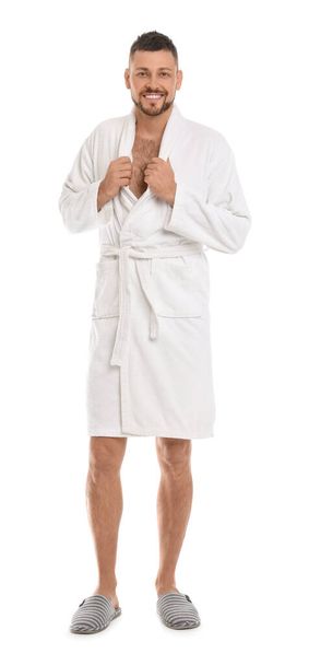 Handsome man wearing bathrobe on white background - Foto, Imagen