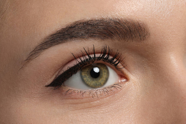 Young woman with permanent makeup of eyes and brows, closeup - Foto, afbeelding