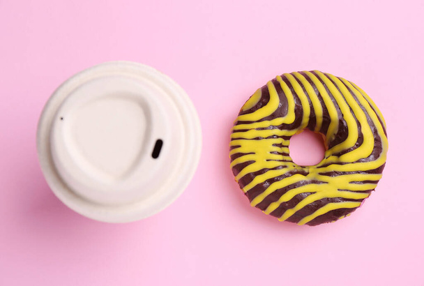 Tasty donut and cup of hot drink on pink background, flat lay - Zdjęcie, obraz