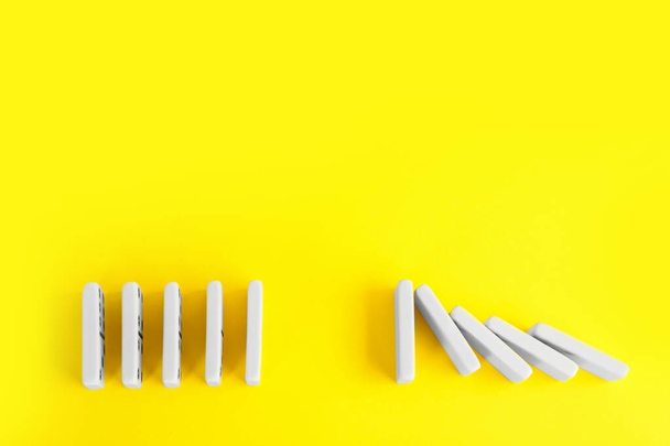 White domino tiles on yellow background, flat lay. Space for text - 写真・画像