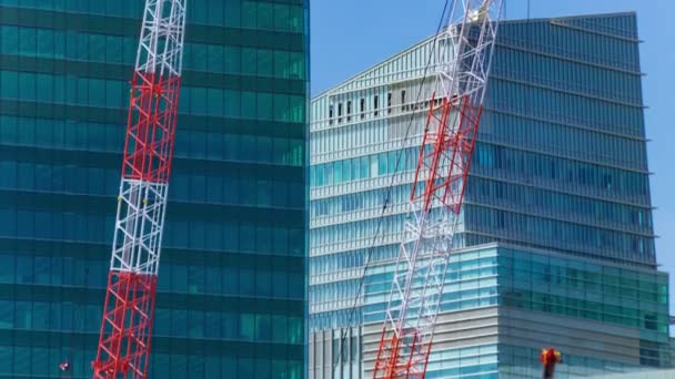 A timelapse of crane at the under construction in Tokyo long shot. High quality 4k footage. Minato district Iikurakatamachi Tokyo Japan 08.09.2022 It is center of the city in Tokyo. - Materiaali, video
