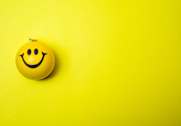Photo of a yellow smiley face on yellow background - Foto, Imagem