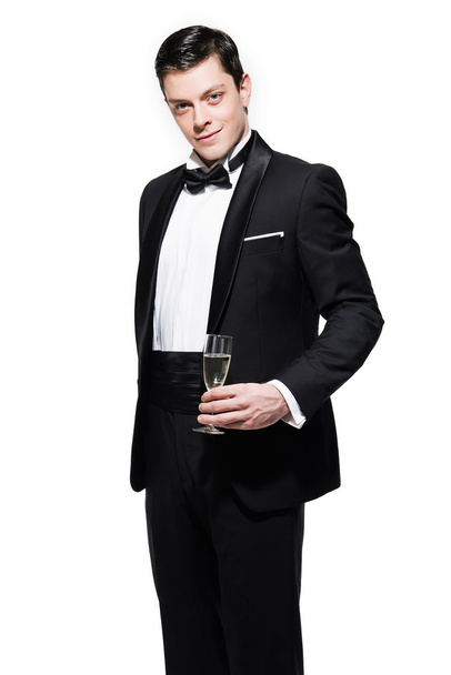 New year's eve fashion man wearing black dinner jacket. Holding  - Fotó, kép