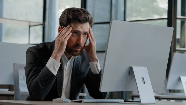 Caucasian bearded 40s middle-aged businessman worker employee man typing laptop feel failure upset with lost of information online error stressed look at computer screen suffer from headache pressure - Photo, image