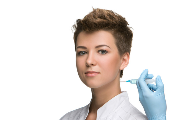 pretty young woman and vaccine syringe - Zdjęcie, obraz