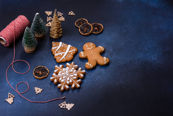 Christmas decorations and gingerbreads on a dark concrete table. Preparing and decorating the house for holiday - Foto, Imagem