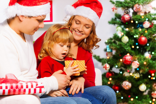 Family sitting near Christmas tree - Φωτογραφία, εικόνα