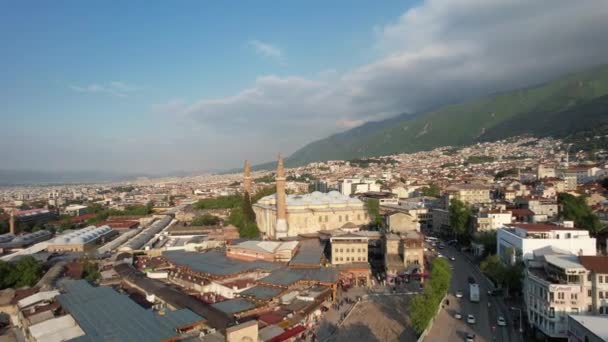 Aerial grand mosque of bursa, bursa great mosque square and its surroundings drone view, urban settlement with historical buildings - Felvétel, videó