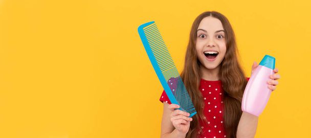amazed teen girl has long hair hold hair brush and lotion. Kid girl hair care, horizontal poster. Banner header with copy space - Foto, afbeelding