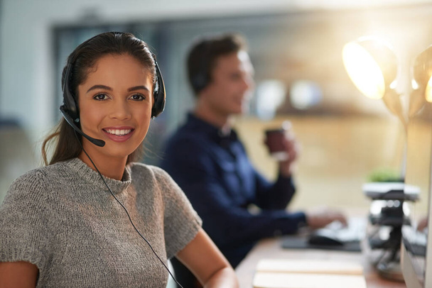 Let them assist you. young agents working in a call center - Foto, Imagem