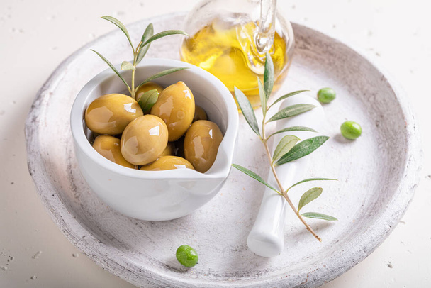Green and tasty olives as summer Greek preserves. Preserves made from olives. - Фото, изображение