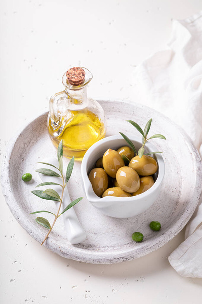 Green and tasty olives with extra virgin olive oil. Preserves made from olives. - Fotoğraf, Görsel