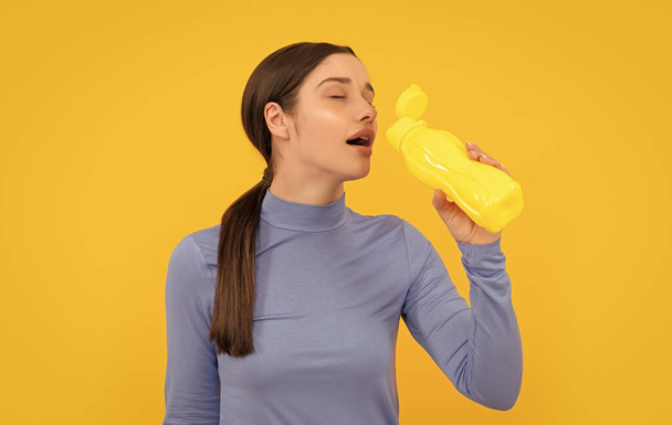 happy young lady drink from sport bottle with water, health. - 写真・画像