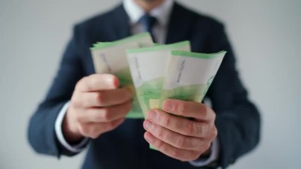Formally dressed man counting euro banknotes, close-up. Concept of investment, success, financial prospects or career advancement. Slow motion - Footage, Video