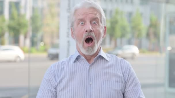 Portrait of Excited Senior Old Man Celebrating Success Outdoor  - Filmati, video