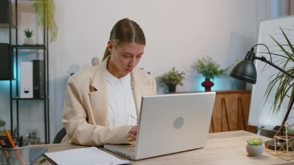I choose you. Business woman programmer software developer working on office laptop pointing to camera, looking with happy expression, making choice, showing direction. Concentrated freelancer girl - Filmati, video