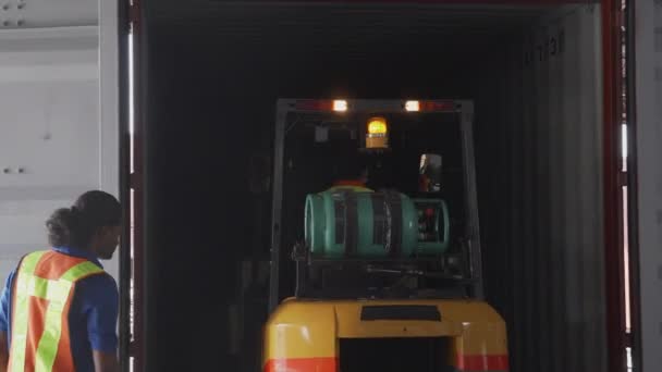 Group worker and man driving forklift lift box or packaging for transportation and distribution unloading containers in the warehouse at factory, employee working in storehouse, logistic concept. - Footage, Video