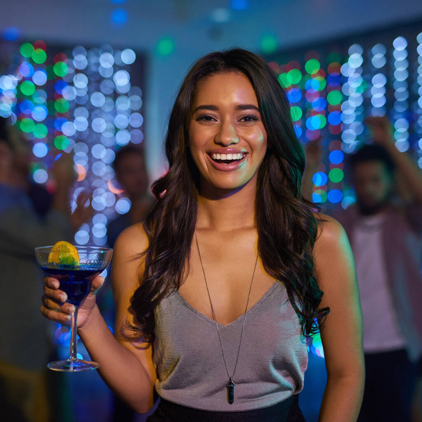 Can you tell how excited I am for the weekend. Portrait of an attractive young woman having a drink while partying in a club - Foto, immagini