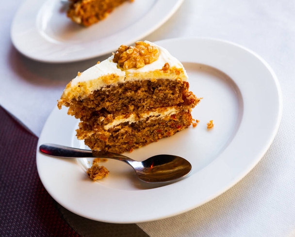 Sweet dessert, carrot cake with walnuts on white plate - Foto, immagini