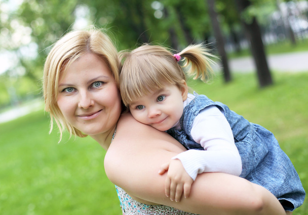 Portrait of mother with daughter outdoor - Фото, изображение