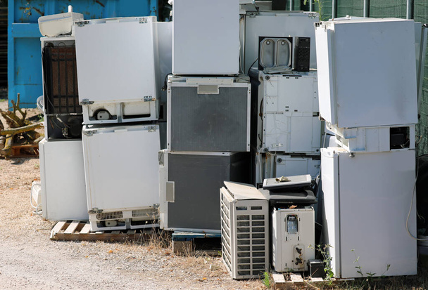 Broken and used appliances in the landfill for the recovery of polluting materials - Photo, Image