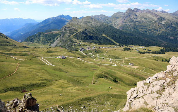 view of the Alpine Pass called Passo Rolle from above in summer with meadows in Northern Italy - Fotografie, Obrázek