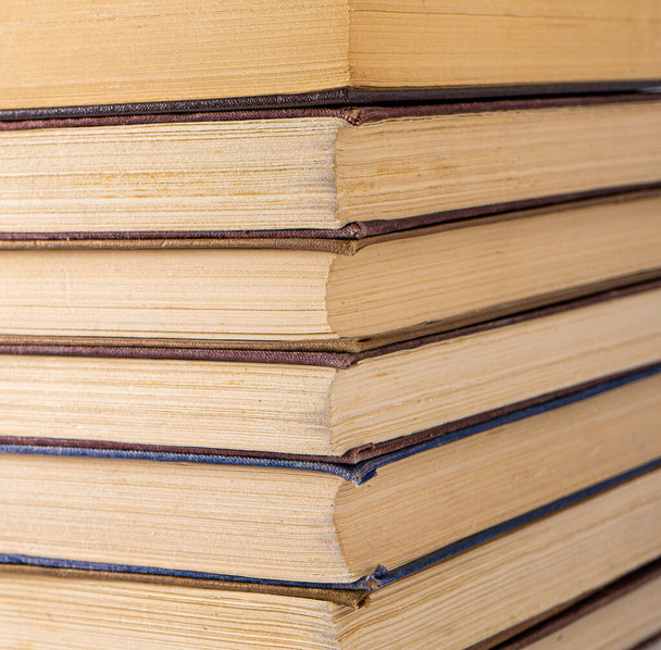 Book background. Stack of books in the library. Old yellow pages of paper books. Learning and knowledge. - Φωτογραφία, εικόνα