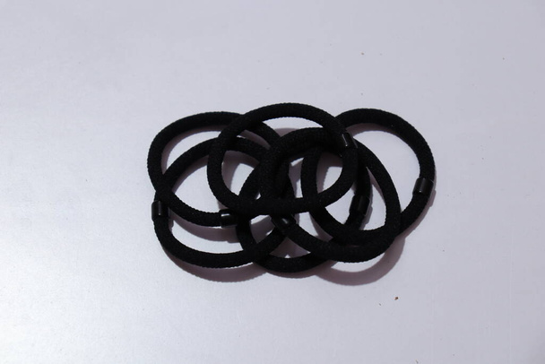 Black Color rubber bands on a white background - Foto, afbeelding