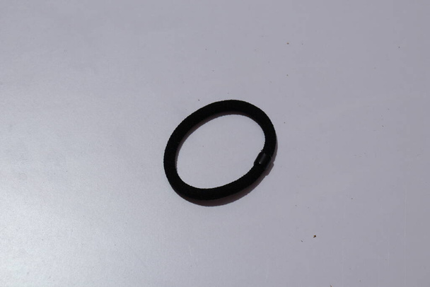 Black Color rubber bands on a white background - Foto, Imagen
