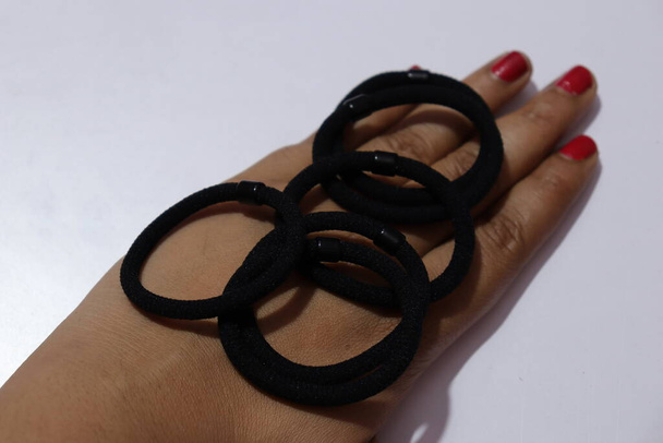 Black Color rubber bands on a white background - Fotó, kép